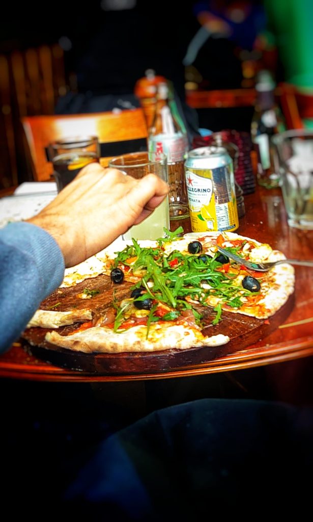 Pizza being eaten at restaurant table