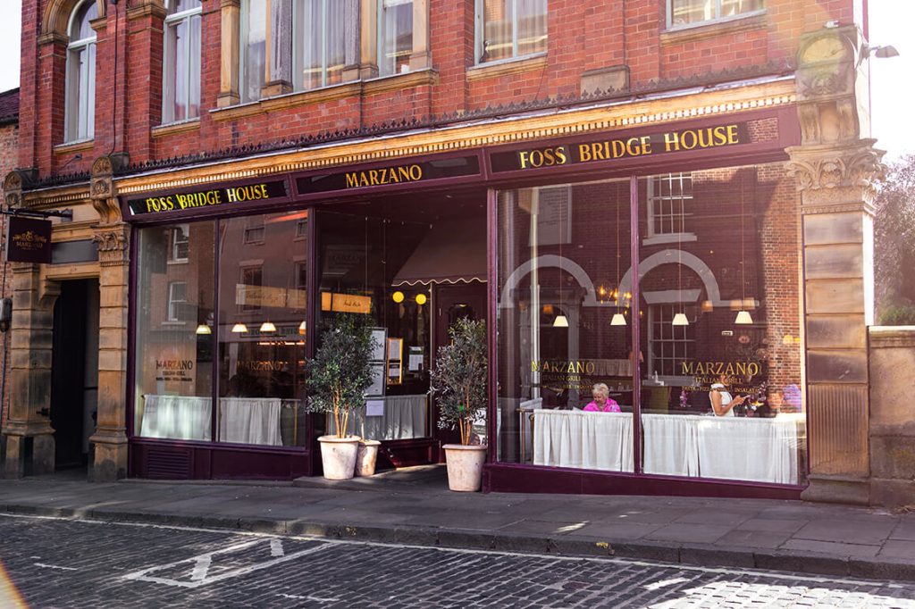 Marzano Italian Grill new location at Foss Bridge House in York, featuring spacious glass façade and Italian restaurant signage.